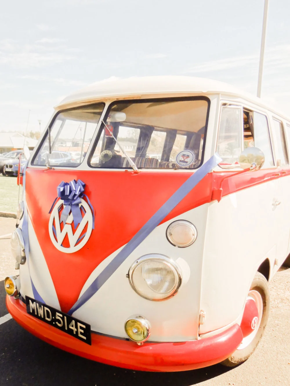 VW Wedding Car hire with blue ribbons and bows