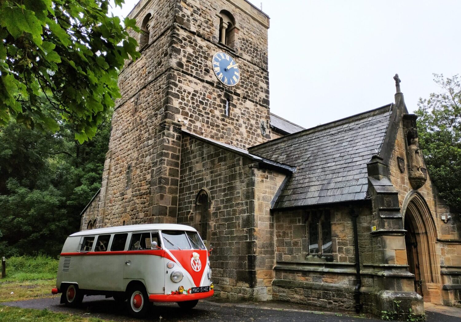 Red and White VW Split Screen Outside Church