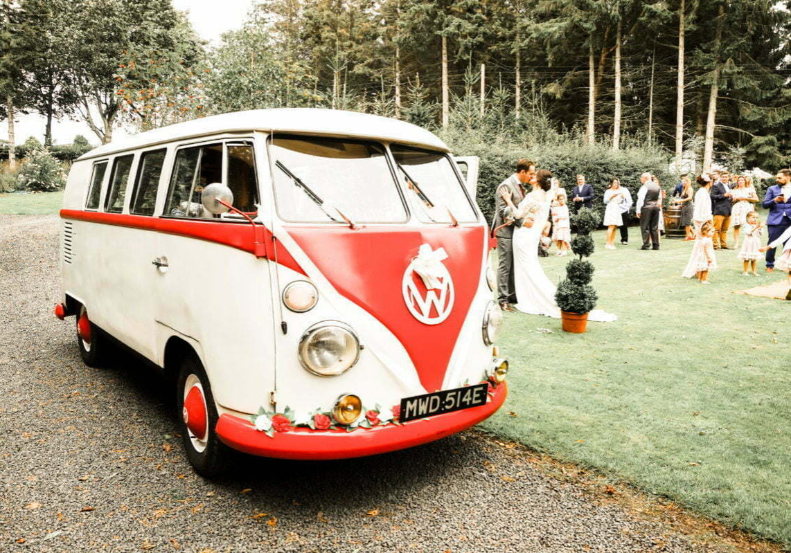 VW Wedding Splitscreen Camper Van with Bride and Groom Kissing